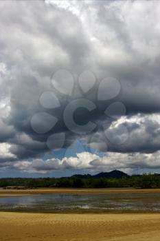 cloudy rain   river   palm  rock stone branch hill lagoon and coastline in madagascar nosy be