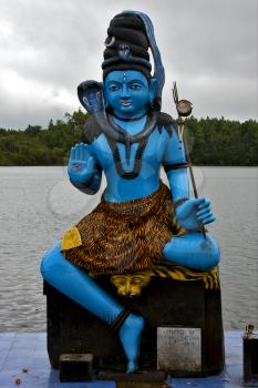  marble blue wood statue of a Hinduism  snake  Shiva vishnu Brahma in a temple near a lake in mauritius africa
