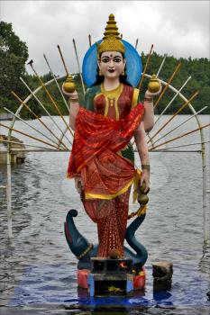 marble  wood statue of a Hinduism  women  Shiva vishnu Brahma in a temple near a lake in mauritius africa
