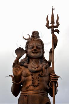 marble  wood gold statue of a Hinduism    Shiva vishnu Brahma in a temple near a lake in mauritius africa
