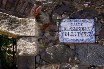 a plate and a brick wall  in calle de las misiones de los tapes  in colonia del sacramento  uruguay
