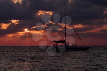 sailing boat sunset red and relax near the jamaica caribbean beach 