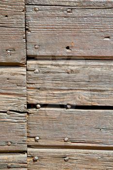 abstract texture of a brown antique wooden old door in italy   europe