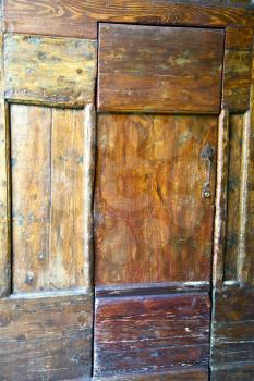  venegono abstract  rusty brass brown knocker in a  door curch  closed wood lombardy italy  varese