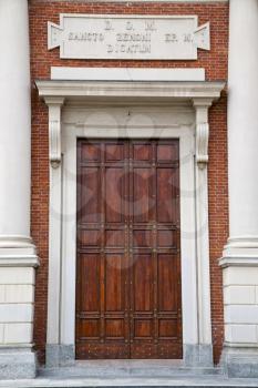  brass brown knocker and wood  door in a church crenna gallarate varese italy