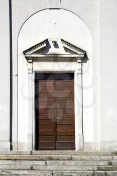 
  italy  sumirago church  varese  the old door entrance and mosaic sunny daY 