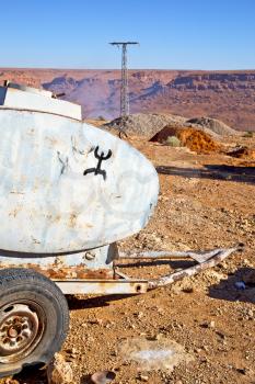 water tank in morocco africa land gray  metal weel and arid