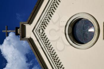 abbiate cross church varese italy the old rose window   and mosaic wall in the sky sunny day