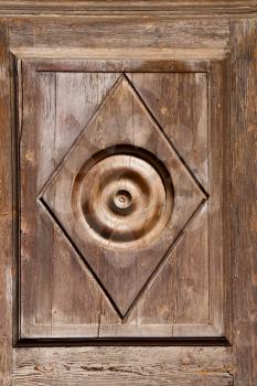 abstract  rusty brass brown knocker in a   closed wood door solbiate arno varese italy