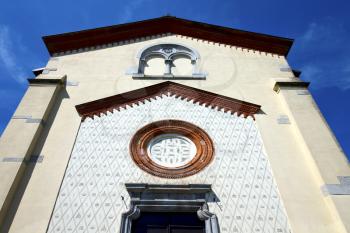 crugnola italy   church  varese  the old door entrance and abstracr mosaic sunny daY rose window