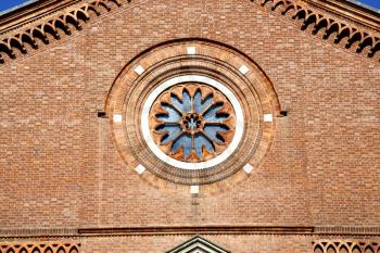  italy  lombardy     in  the castellanza   old   church   closed brick tower   wall rose   window tile   