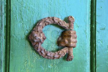 abstract  rusty brass brown knocker in a   closed wood door olgiate olona varese italy
