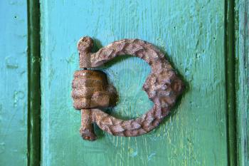 abstract  rusty brass brown knocker in a   closed wood door olgiate olona varese italy

