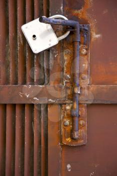 
abstract cross   steel  padock in a   closed rusty door   varese italy mornago