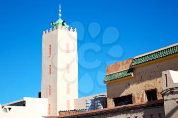 old brick tower in morocco africa village and the sky