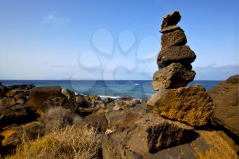 rock spain landscape  stone sky cloud beach   water  in lanzarote  isle 
