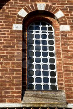  italy  lombardy     in  the   legnano  old   church   closed brick tower   wall rose   window tile   