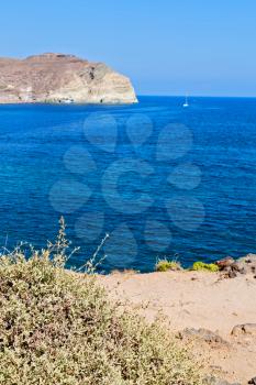 in europe greece santorini island hill and rocks on the summertime beach 