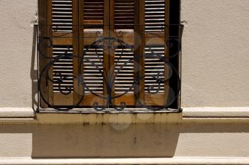 old window grate and shadow in the centre of colonia del sacramento uruguay