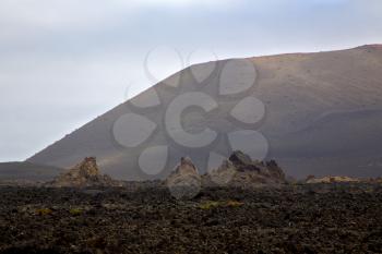 volcanic stone in los volcanes lanzarote  spain  timanfaya  rock  sky  hill and summer 
