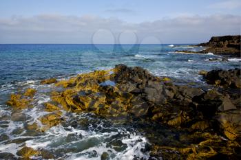 water  in lanzarote  isle foam rock spain landscape  stone sky cloud beach  
