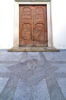 door   in italy  lombardy   column  the milano old   church   closed brick  pavement