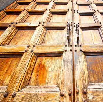 abstract texture of a brown antique wooden old door in italy   europe