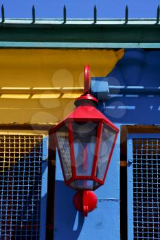 red street lamp  and a colorated  wall in la boca buenos aires argentina
