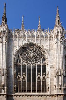 spire italy church  rose window  the front of the duomo  in milan and column
