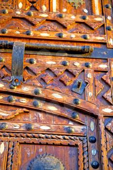 metal grey   morocco in    africa the old wood  facade home and rusty safe padlock 