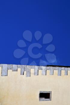 cross sumirago lombardy italy  varese abstract   wall of a curch broke brike pattern sunny day  and sky 
