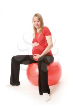 Young training pregnant woman isolated on white