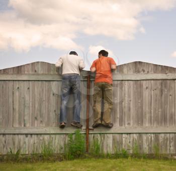Photo of two boys on the fence