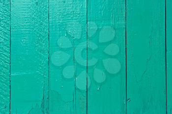 Fragment of old wooden fence painted in bright aquamarine