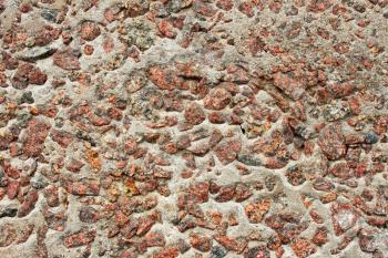 Detail of multicolor stone wall with granite colored stones