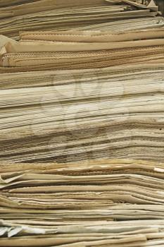 Stack of the old yellowed newspapers close up