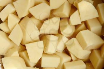 Cut into cubes potato tubers in water before cooking