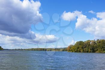Beautiful cloudy scenery over the river of early autumn