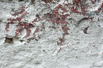 Fragment of old concrete wall with shelled multi-coated surface with lame and different dyes