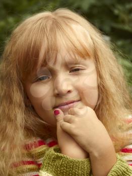 Beautiful small Caucasian girl outdoors portrait close-up
