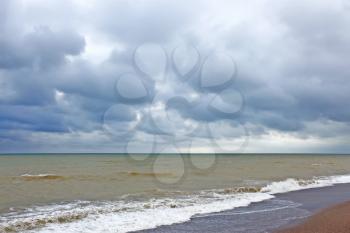 Storm clouds over the sea surface. Coastal sea water after the storm contaminated dredged from the seabed sand
