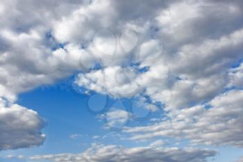 Cloudscape. White clouds floating through a blue sky, warm spring day