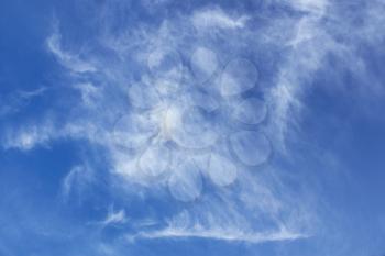 Abstract image of oblong white clouds in blue sky