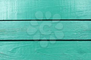 Fragment of wooden fence painted in bright aquamarine