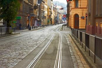Old cobbled road with tram tracks in the downtown at the morning in Lviv, Ukraine