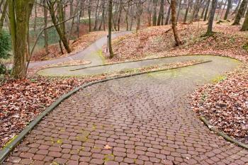 Park paved walkway that runs steeply down, early spring evening in Lviv, Ukraine