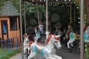 Girls rides on the carousel with horses 18692