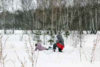 Two girls walking and playing in the winter forest and having fun with snow 29998
