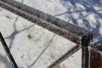 The snow-covered metal fence 30409