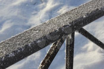 The snow-covered metal fence 30411